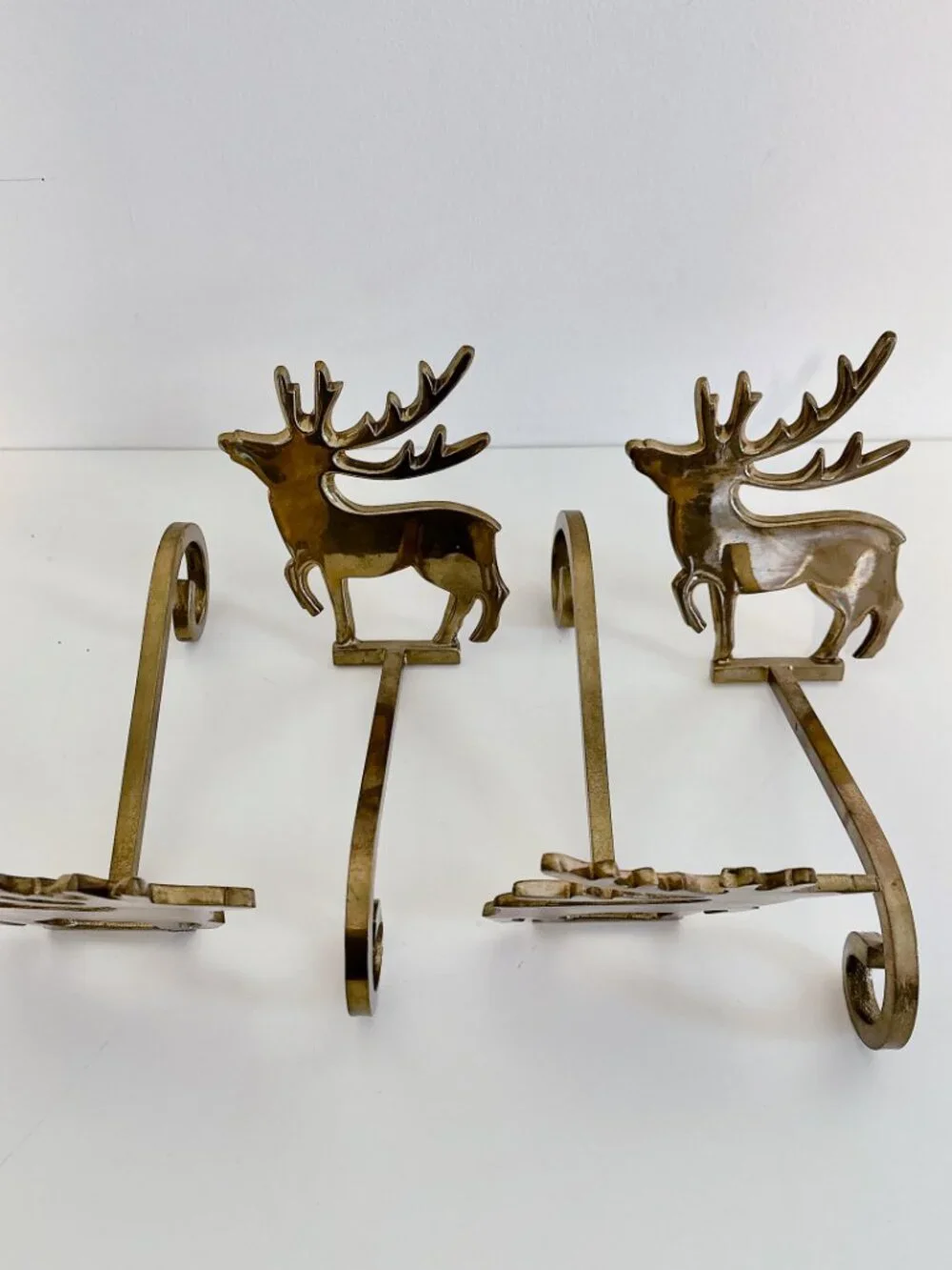SET OF FOUR BRASS REINDEER MANTEL STOCKING HANGERS
